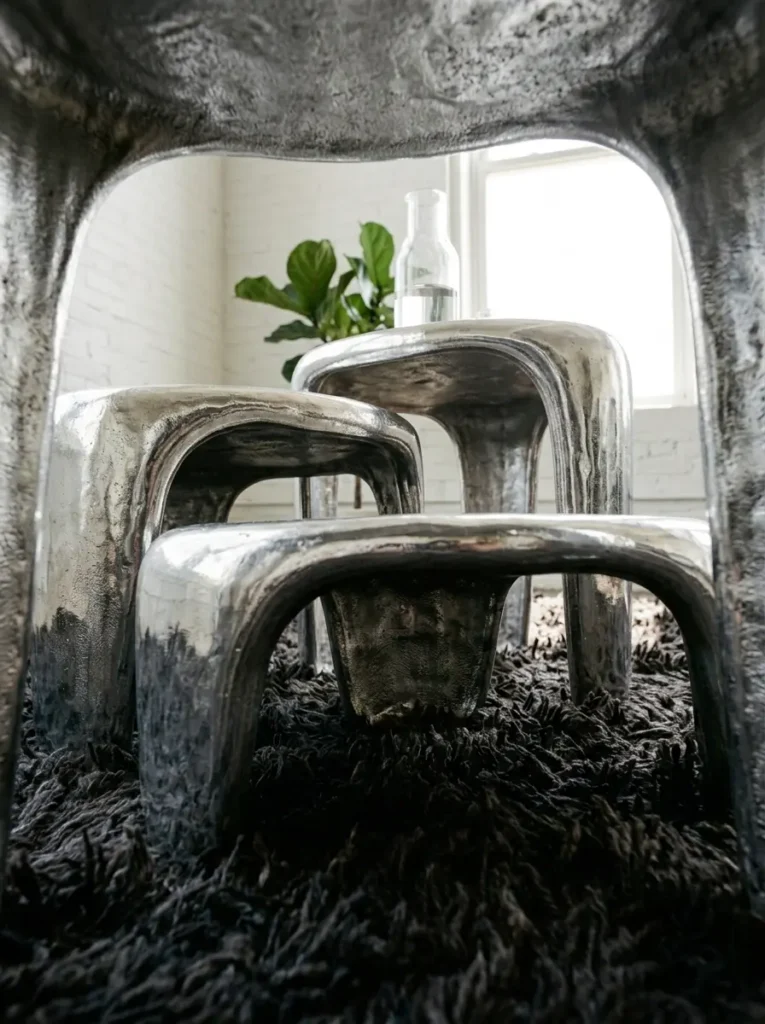 Liquid Metal Nesting Tables Three polished silver nesting tables resembling irregular pools of liquid metal