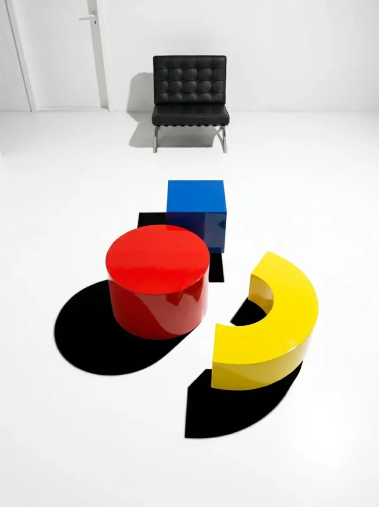 Primary Color Geometric Shapes Brightly colored geometric shapes including a red cylinder blue cube and yellow arch.