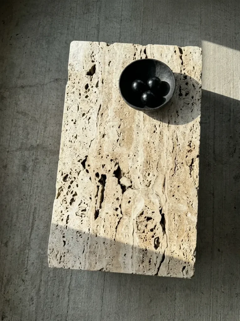Raw Travertine Stone Block Table Rectangular block coffee table made of porous beige travertine stone with deep natural holes