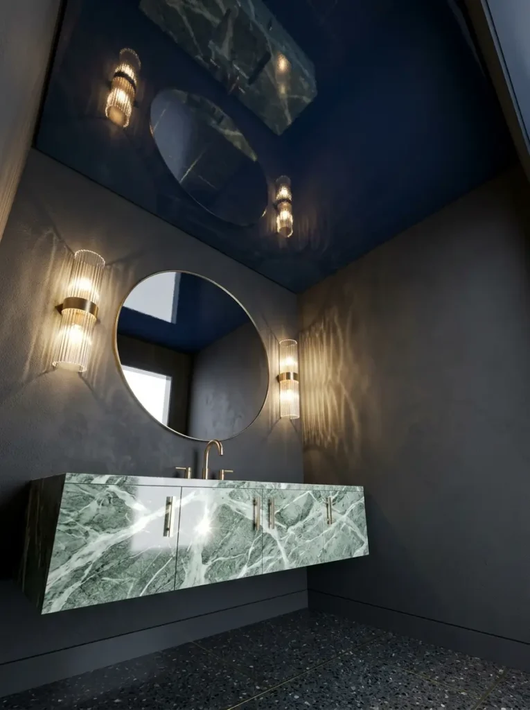 Midnight blue high gloss lacquered ceiling reflecting glowing wall sconces and a floating green marble vanity in a dark powder room.