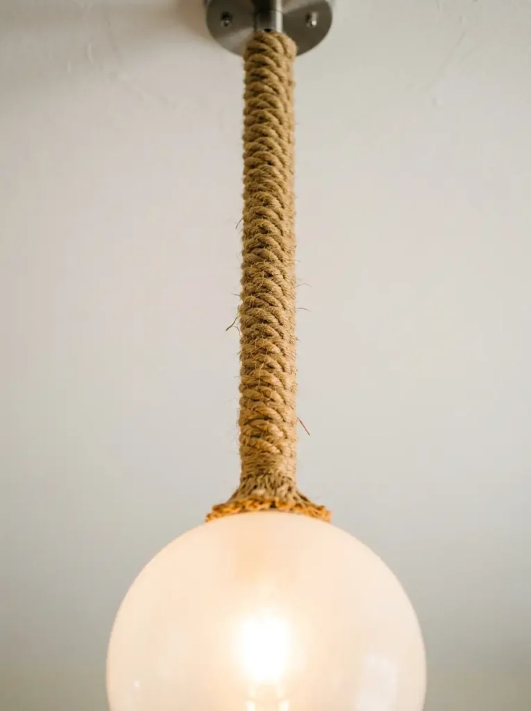 Jute Wrapped Pendant Cord | StylishGalore Pendant light cord wrapped tightly in natural brown jute rope hanging from a ceiling