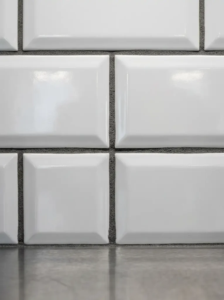 Peel and Stick Subway Tile | StylishGalore Close up of glossy white peel and stick 3D subway tiles with dark grey faux grout lines