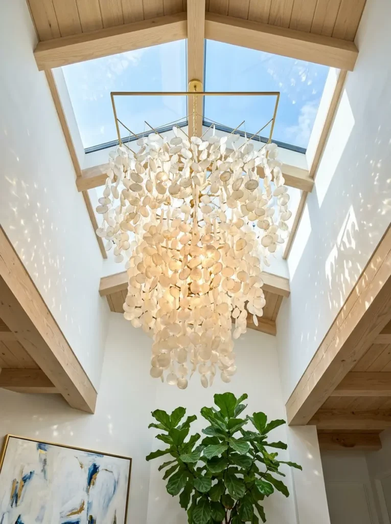 Large capiz shell chandelier hanging below a skylight.