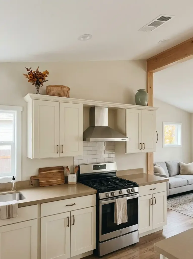 Mobile home kitchen cabinets styled with sparse rust foliage, woven baskets, and understated fall accents above