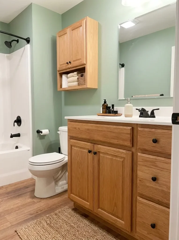 Uncluttered vanity with toiletries hidden inside closed storage in a mobile home bathroom.