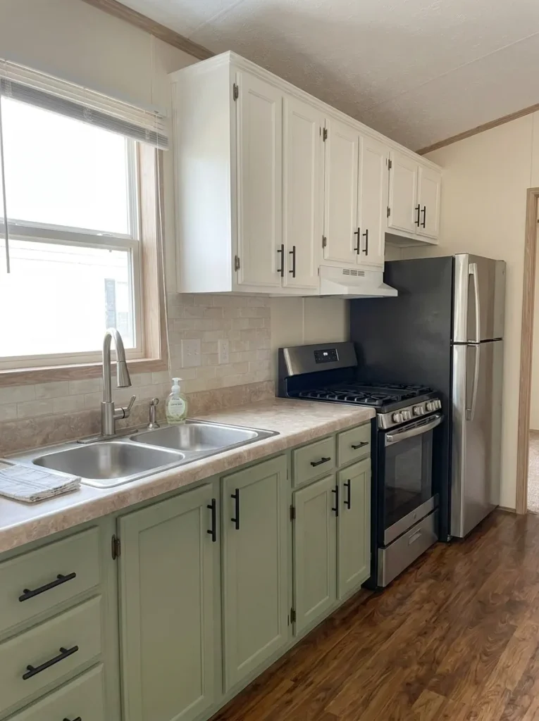 Refreshed mobile-home sink area with the plumbing location unchanged and surrounding finishes simplified.