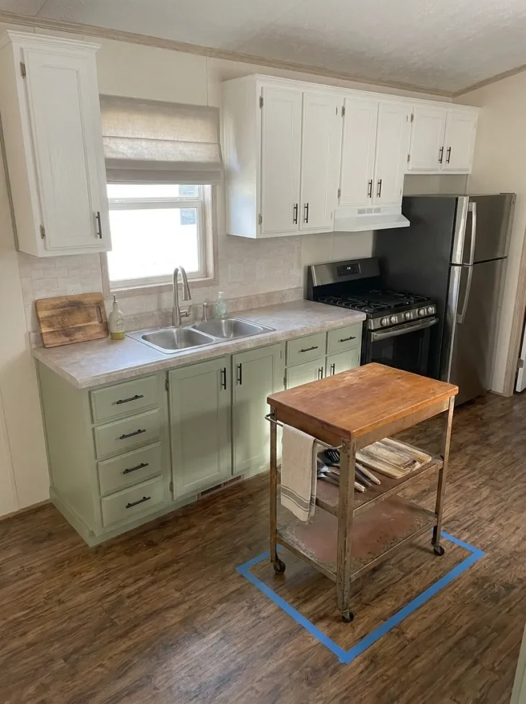 Narrow secondhand cart being tested as extra prep space in a compact mobile-home kitchen without blocking circulation.
