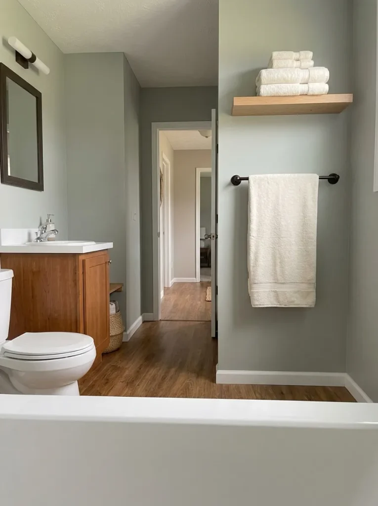 Towel hanging within easy reach of the shower in a compact mobile home bathroom.