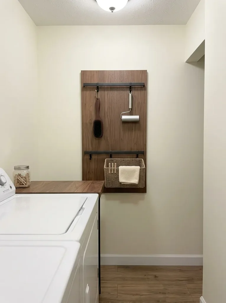 Edited rail and basket utility board organizes frequently used tools on a small mobile-home wall.