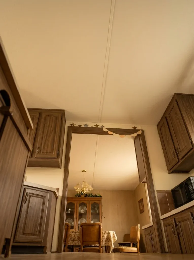 A few lightweight ceiling accents create atmosphere while preserving visual breathing room overhead.
