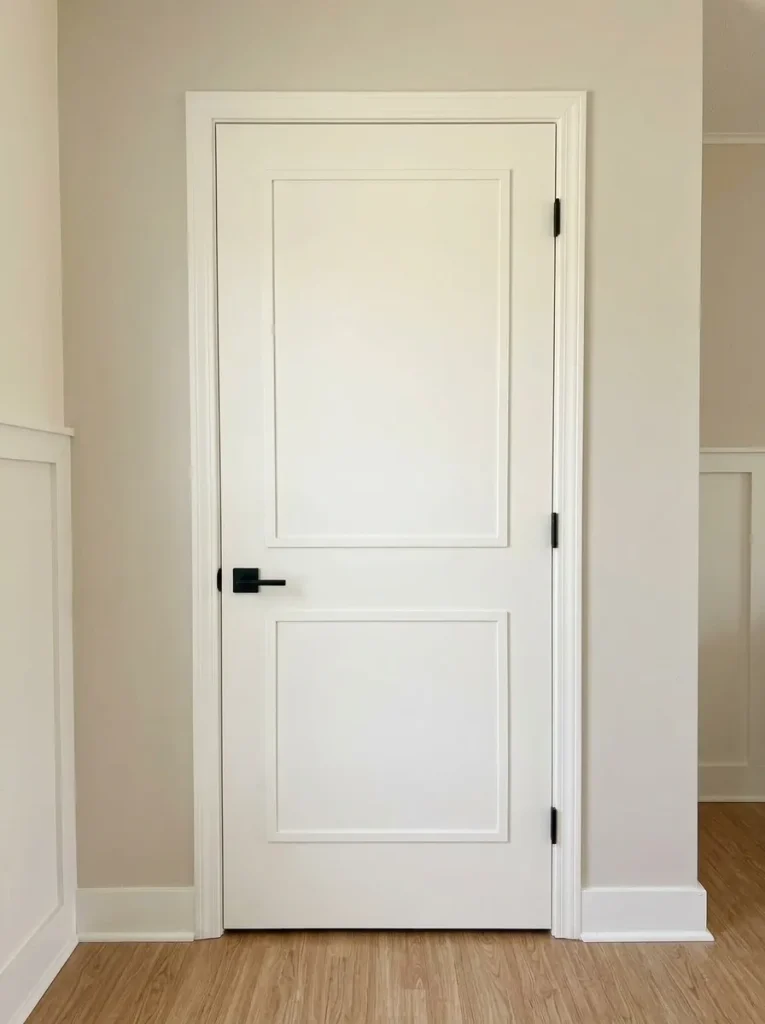 Plain mobile-home interior door upgraded with lightweight panel detailing while retaining its original clearance and function.