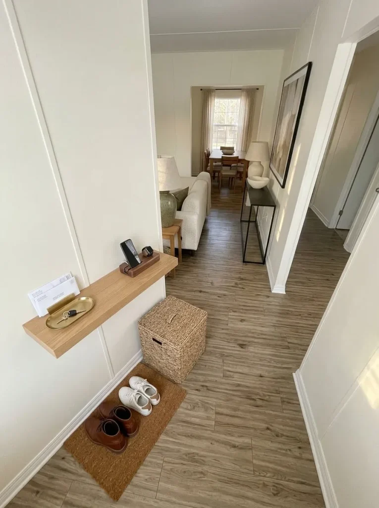 Mobile home entry and hallway transition with compact shoe storage, key tray, basket and charging area for quick daily resets.