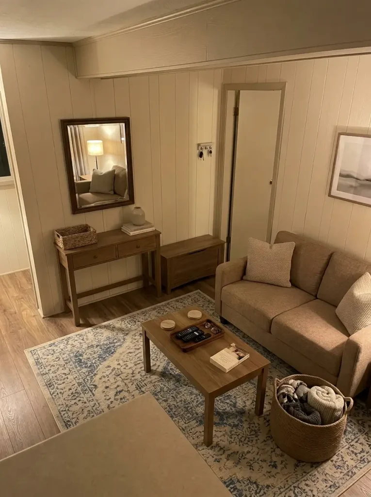 Mobile home entry and living room using baskets, closed storage and trays where everyday clutter naturally collects.