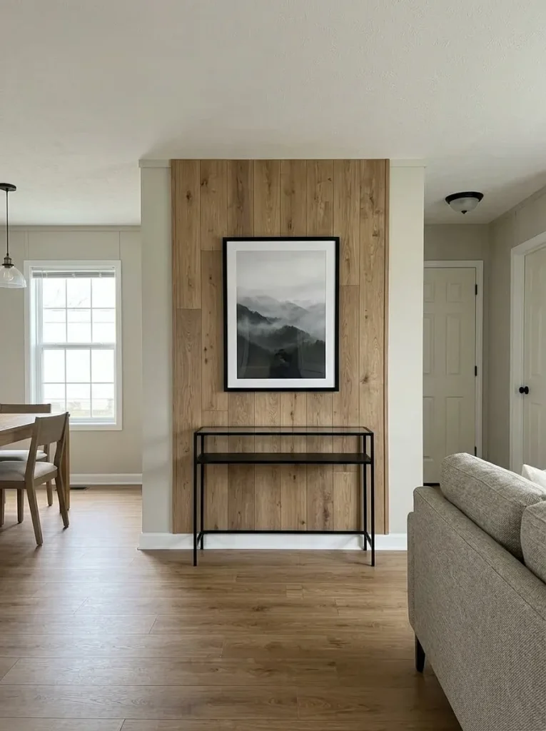 Mobile home living room with reclaimed wood limited to a central console area while surrounding walls remain warm greige.
