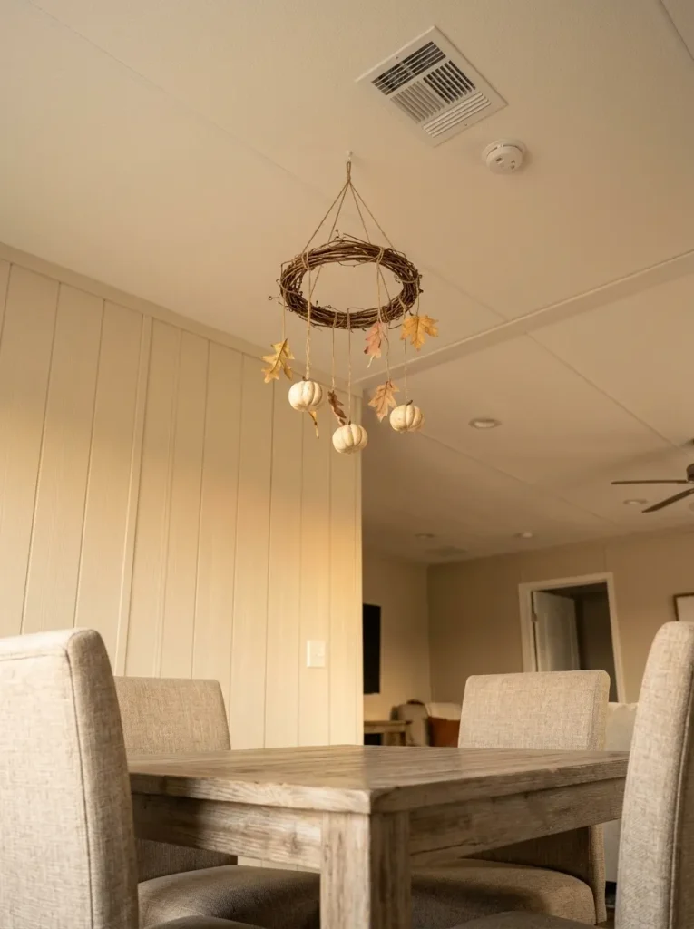 Overhead fall décor works best when it uses a genuinely inactive ceiling zone rather than competing with circulation or fixtures.
