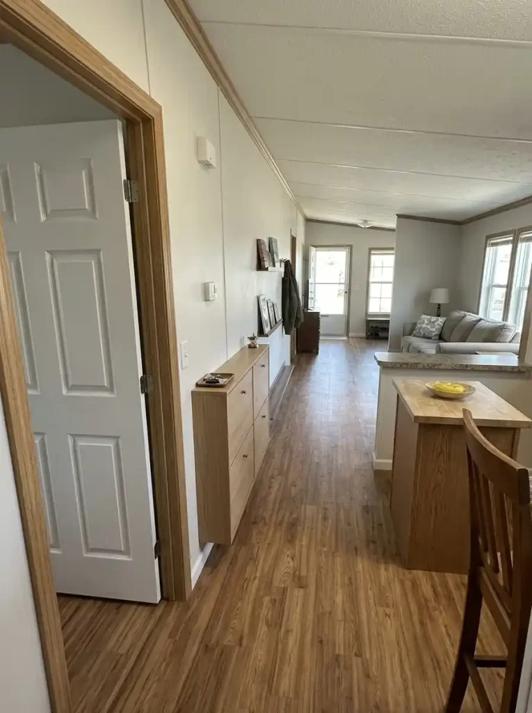 Shallow console on a single-wide passage wall with clear space for the nearby doorway, dining chair and walking route.
