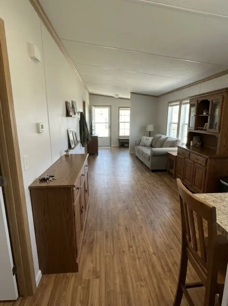 Two deeper storage units staggered along opposite sides of a single-wide living area so they do not narrow the same section of floor.