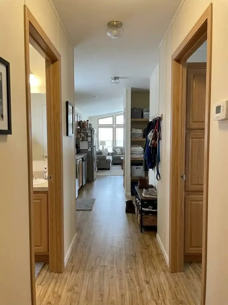 Long single-wide interior showing daily-use storage near living and kitchen areas and reserve storage closer to the private hallway.